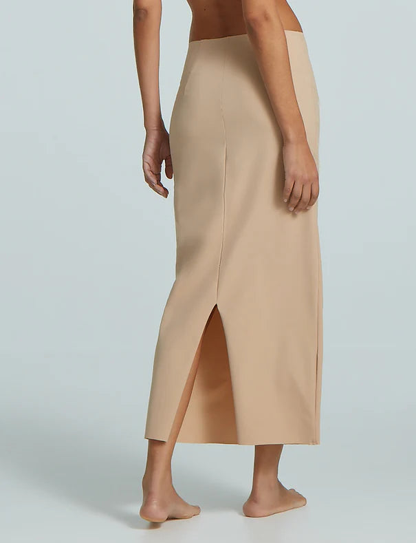 Beige skirt worn by a person on a light gray background