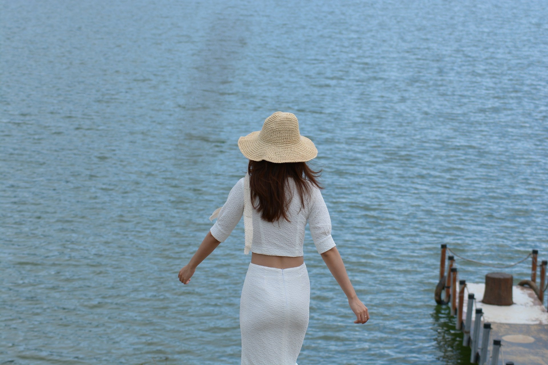woman wearing a white top with a white skirt