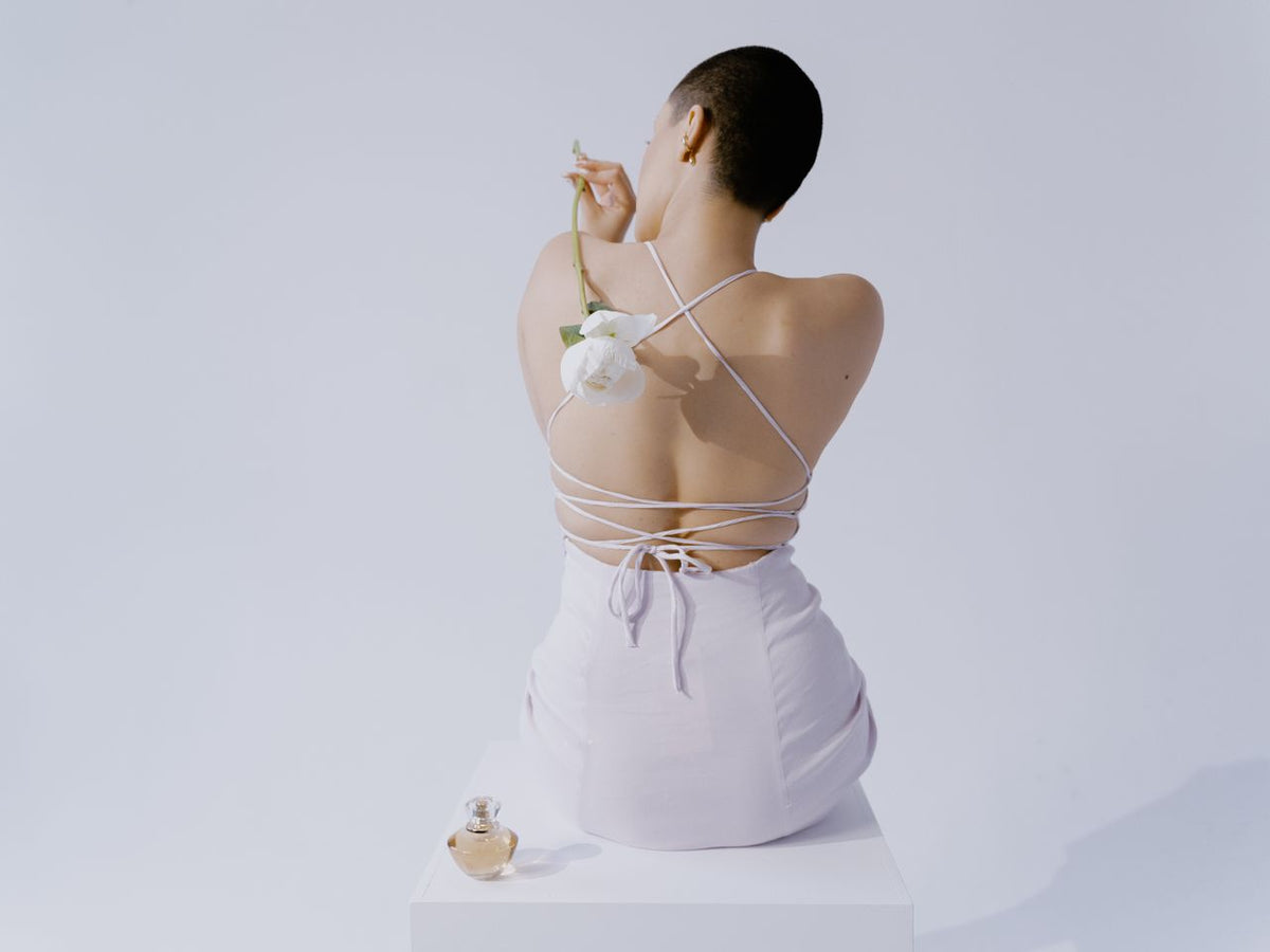 A woman wearing a white backless dress