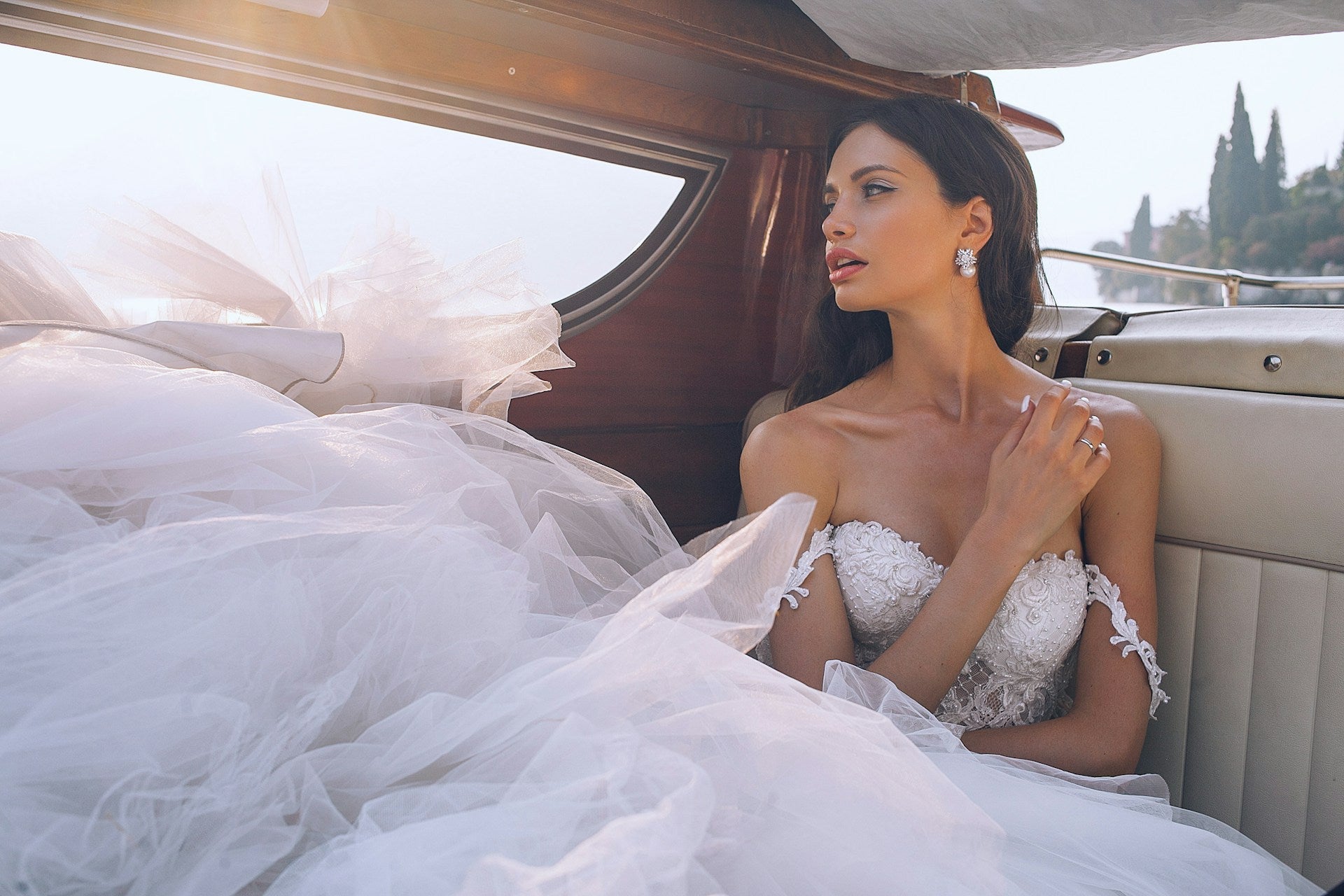 woman in a wedding dress sitting in a car