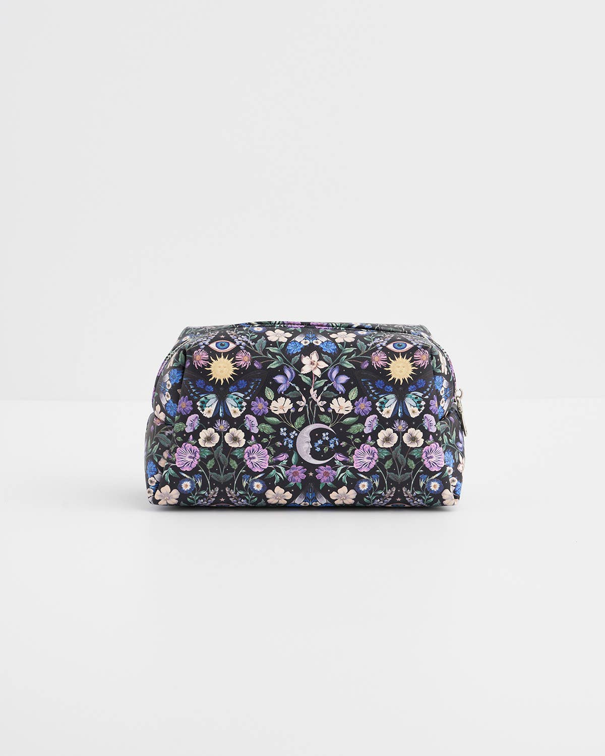 A small zippered cosmetic pouch with an intricate floral and butterfly pattern in purple, blue, pink, and yellow on a dark background, set against a plain light gray studio backdrop.