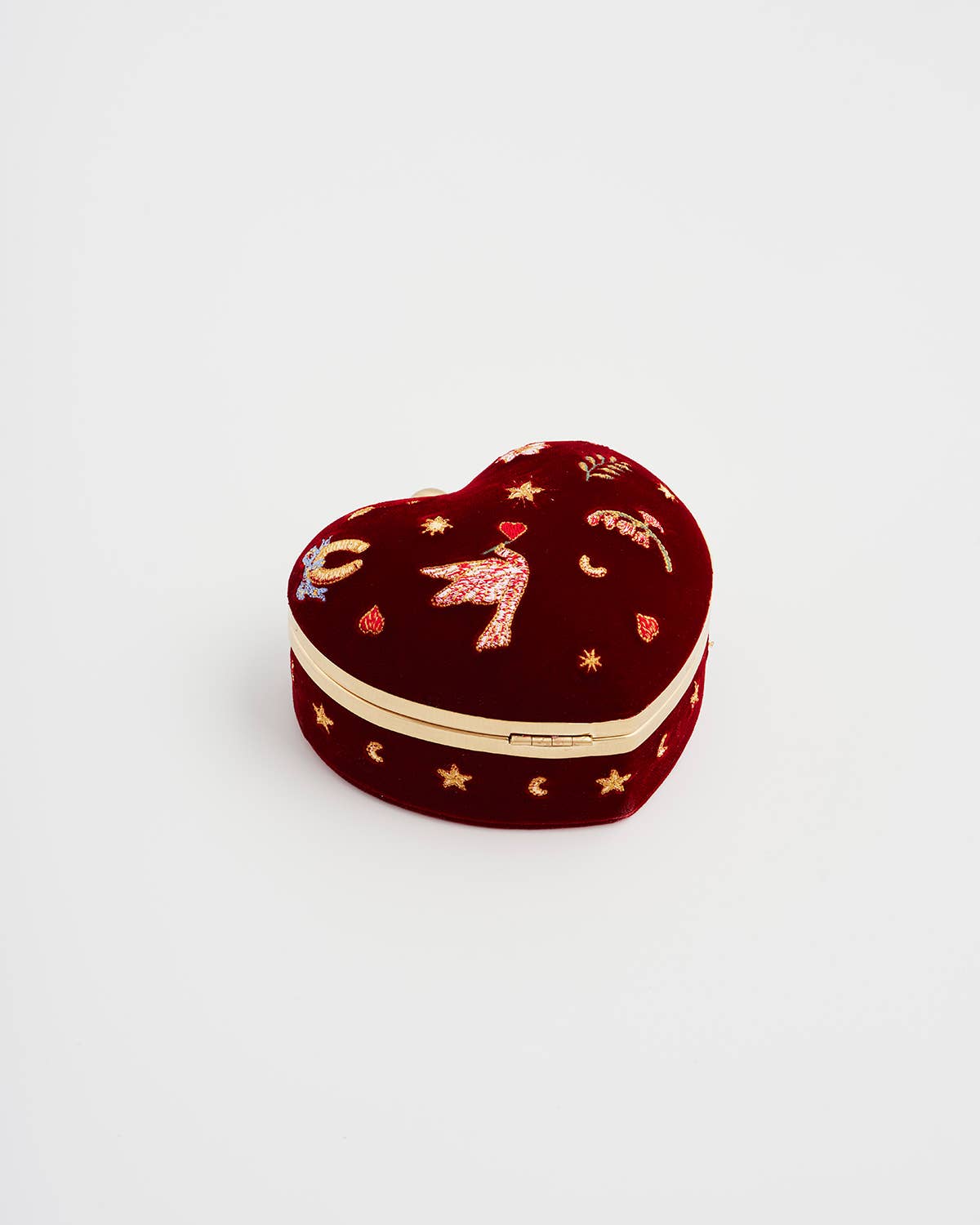 Heart-shaped jewelry box with embroidered designs on a white background