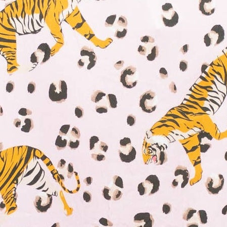 Fabric swatch of tiger print on solid pink background