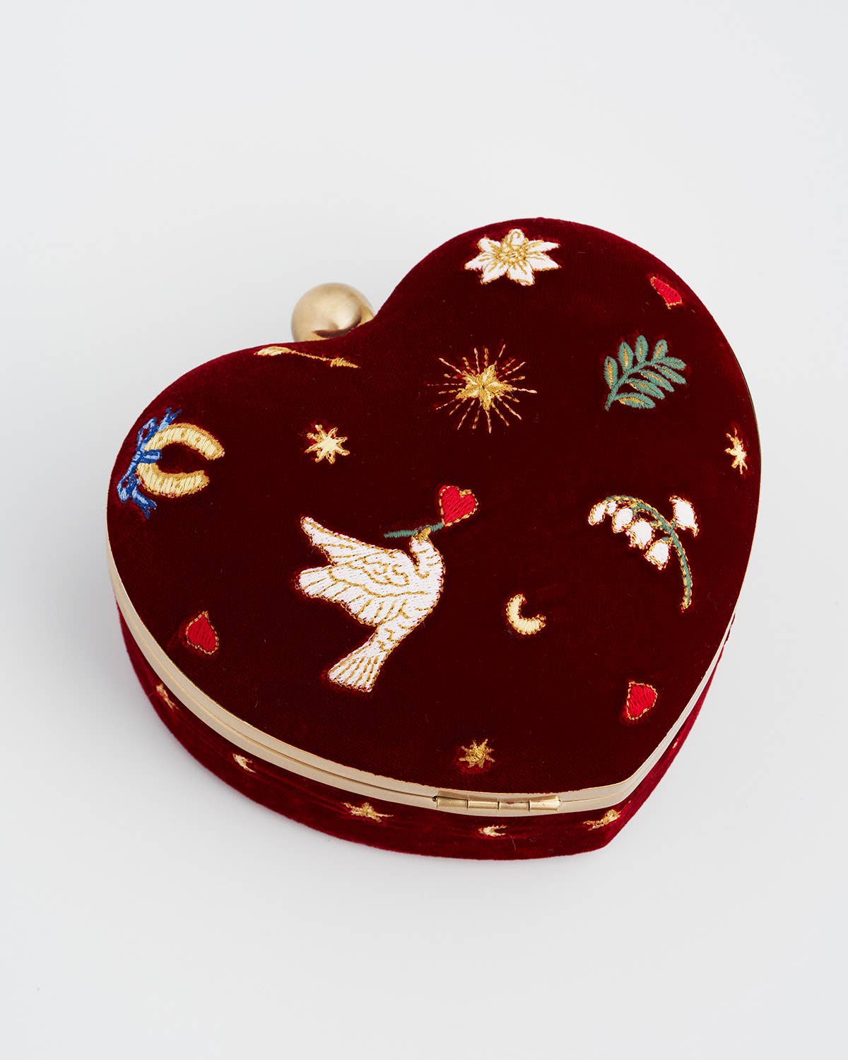 Heart-shaped embroidered clutch bag on a light gray background
