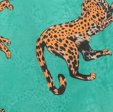 Fabric swatch of tiger on green background