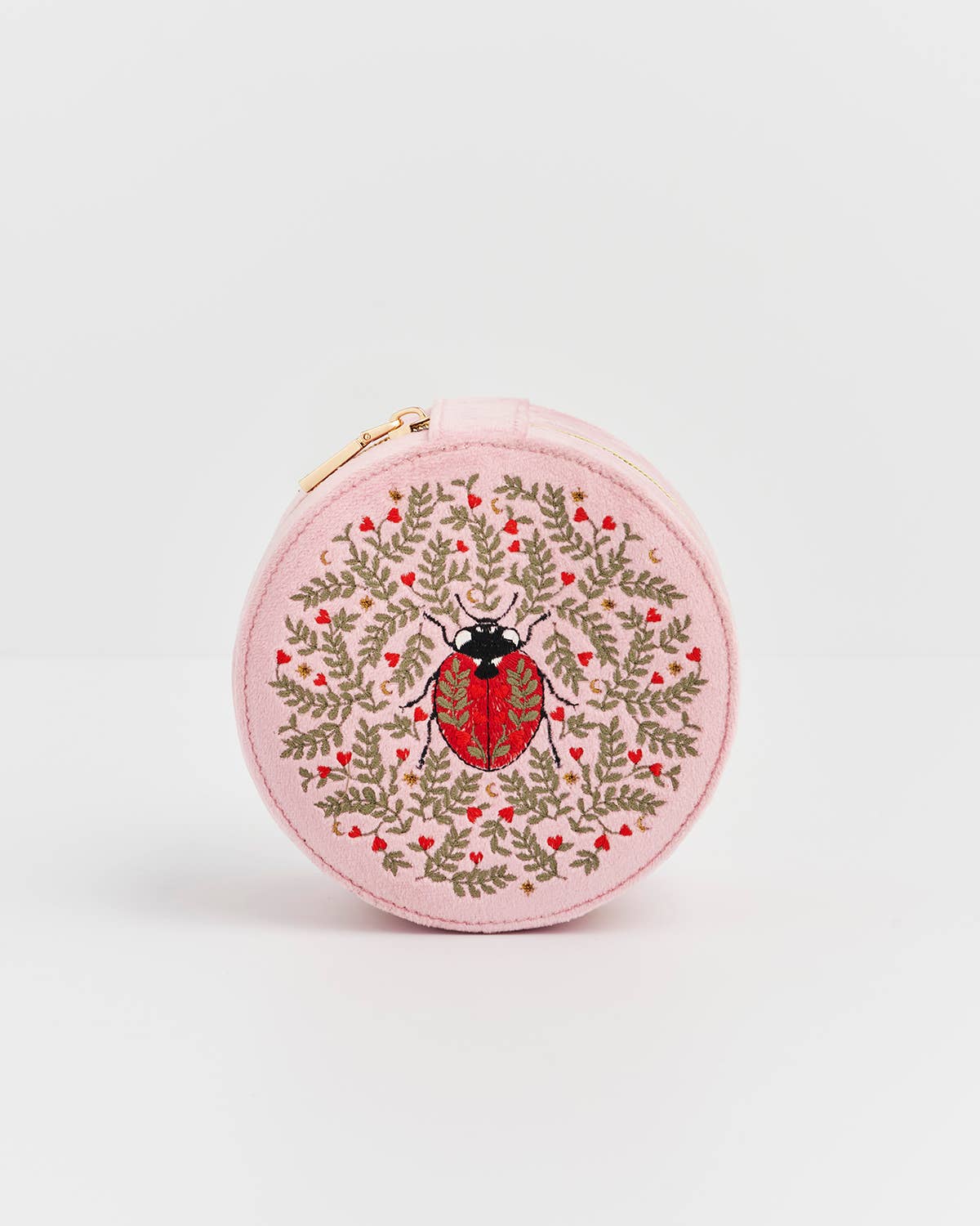 Round pink pouch with a ladybug design on a white background