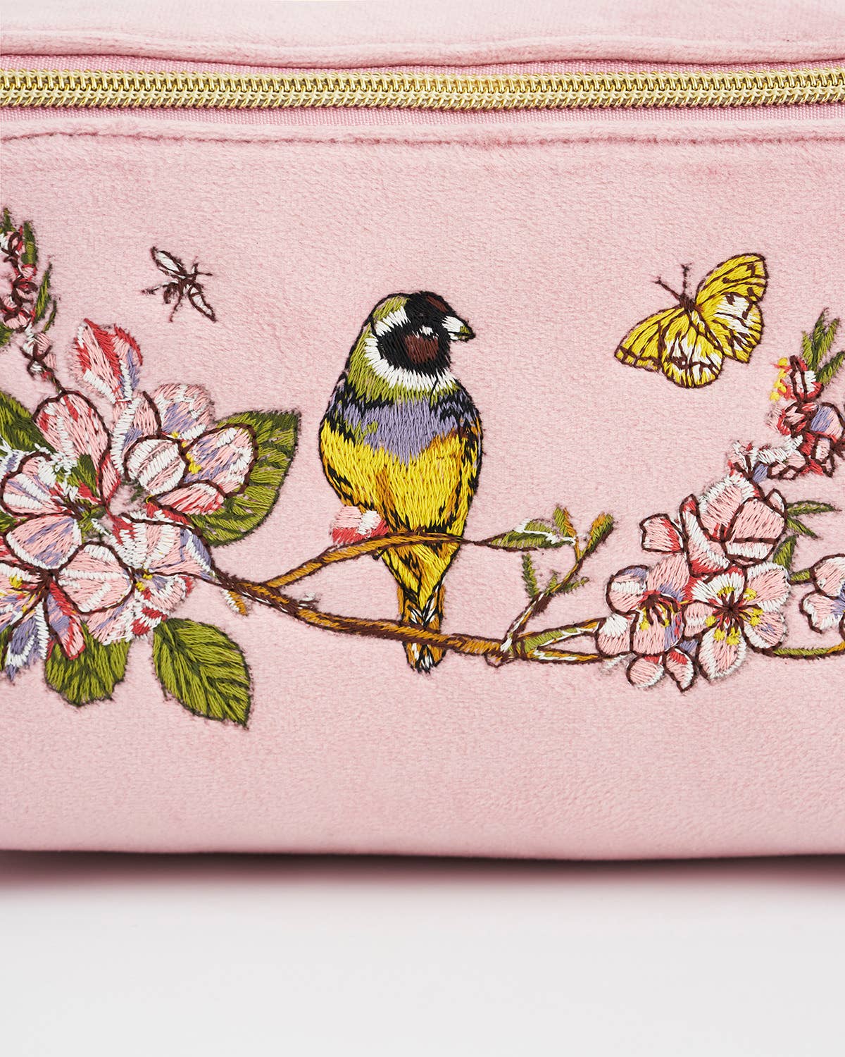 Pink pouch with embroidered bird and floral design on a white background
