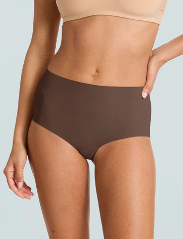 Person wearing brown high-waisted underwear on a light gray background