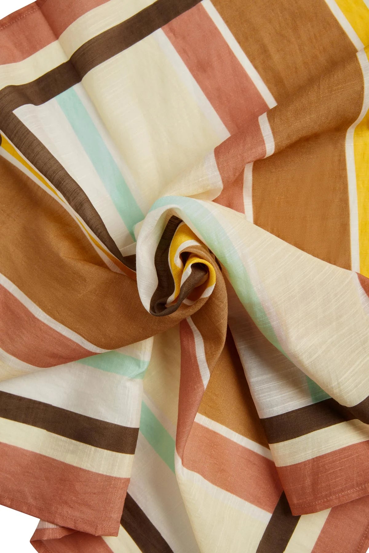A close-up of a lightweight striped fabric draped in soft folds, featuring horizontal bands of terracotta, mustard yellow, cream, brown, and pale mint green.