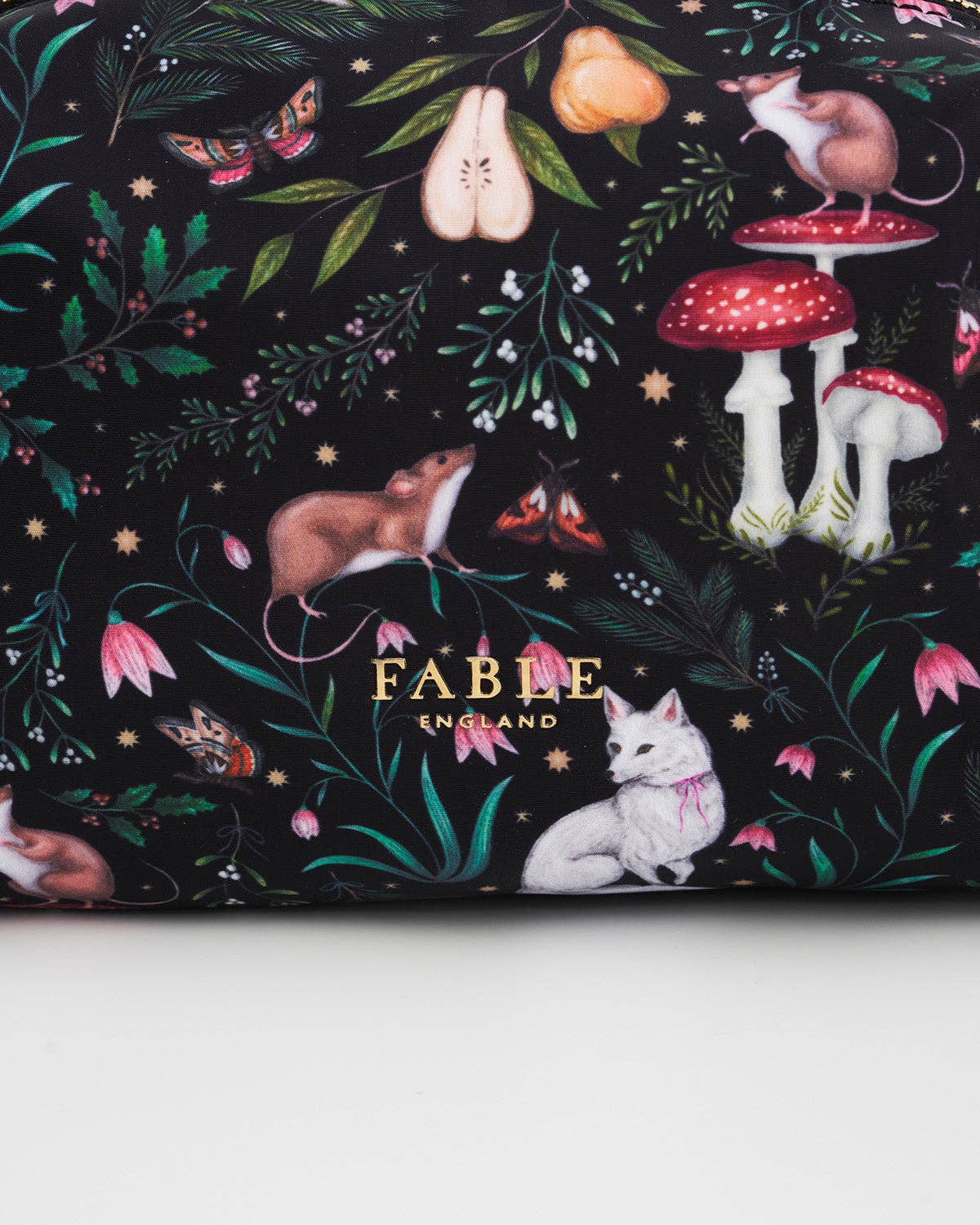 Fable England fabric with forest animals and plants on a black background