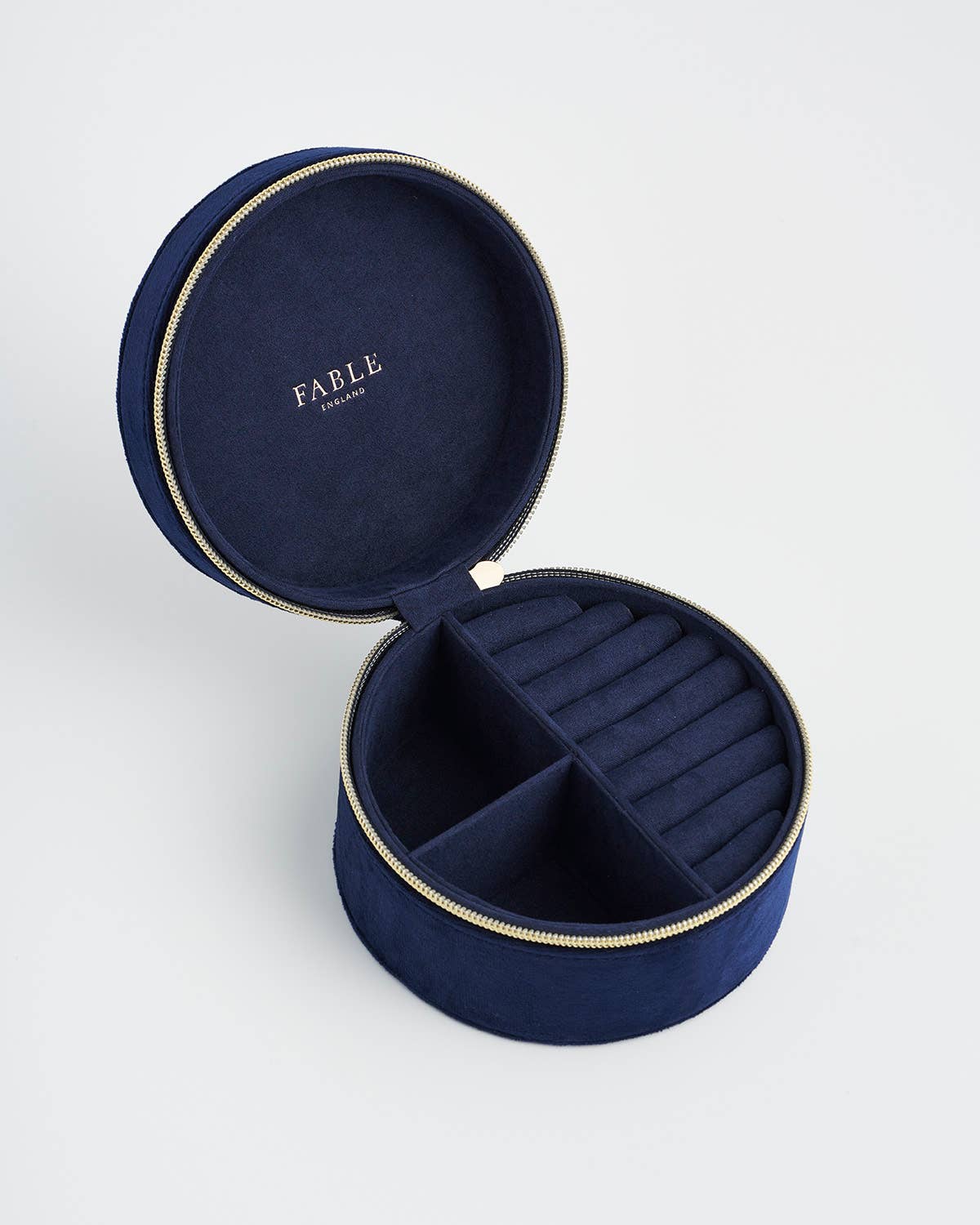 Navy blue jewelry box with 'Fable' branding on a light gray background