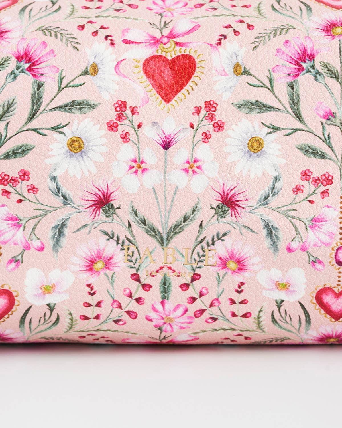 Floral fabric with hearts and flowers on a pink background