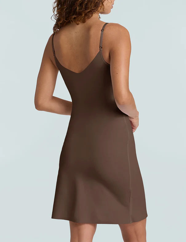 Brown slip dress worn by a model on a light gray background