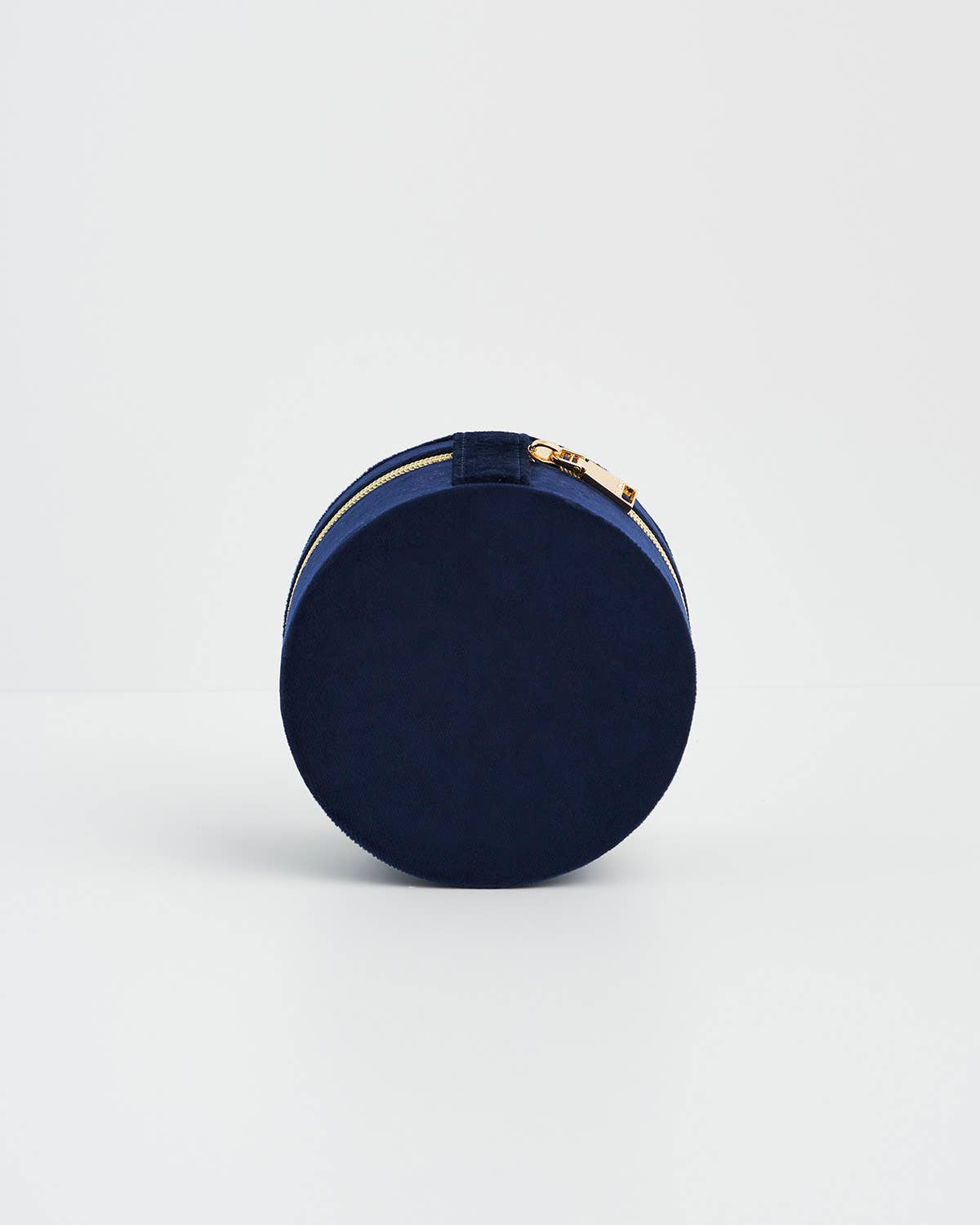 Navy blue round box with gold accents on a light gray background