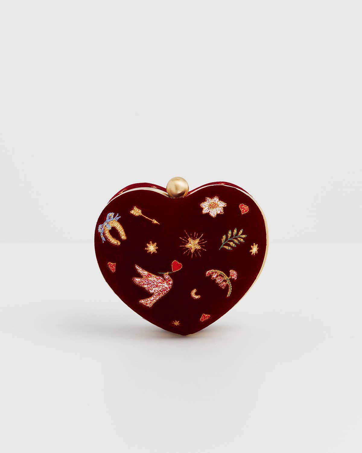 Heart-shaped clutch with decorative elements on a white background