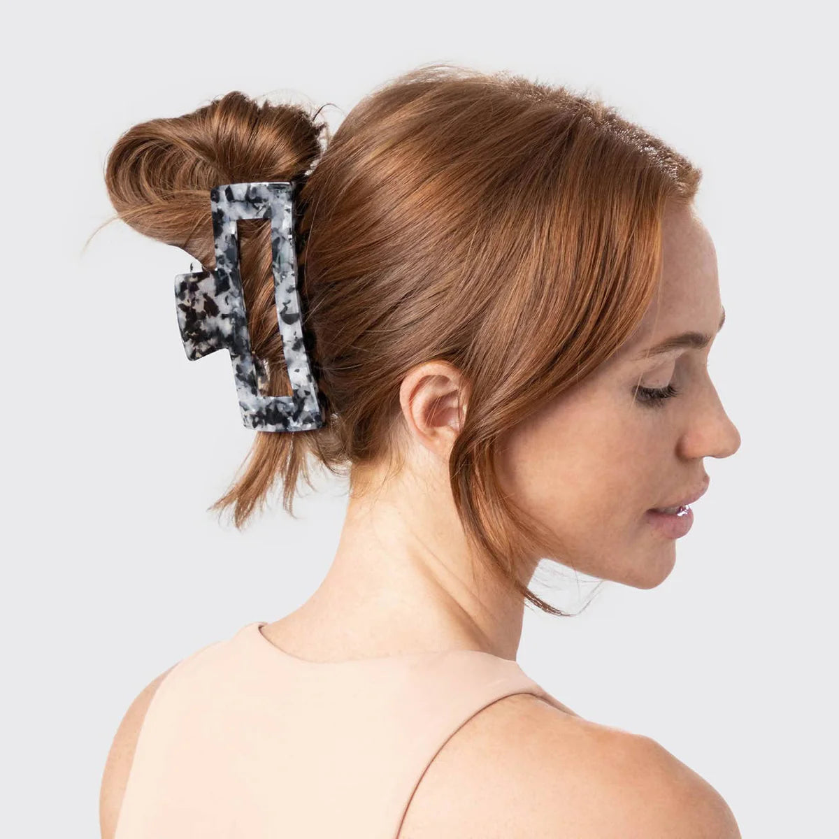 Woman wearing a luxury claw clip hair accessory